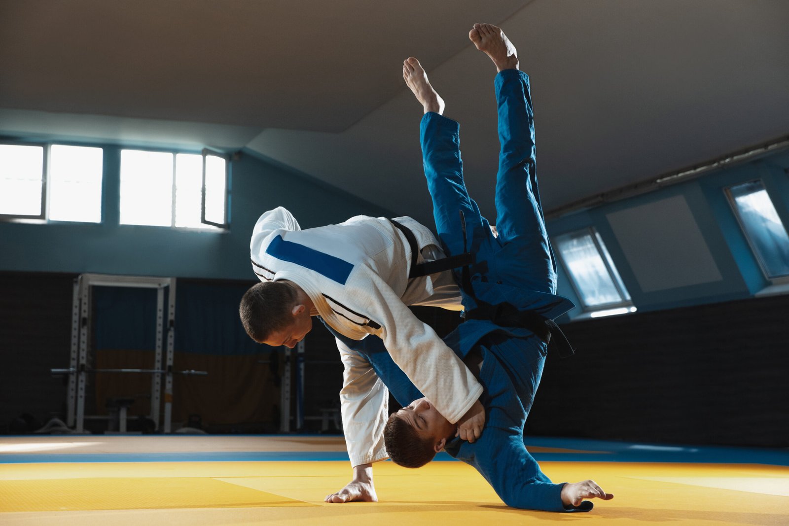 Treinos two young judo fighters in kimono training martial arts in the gym with expression, in action and motion